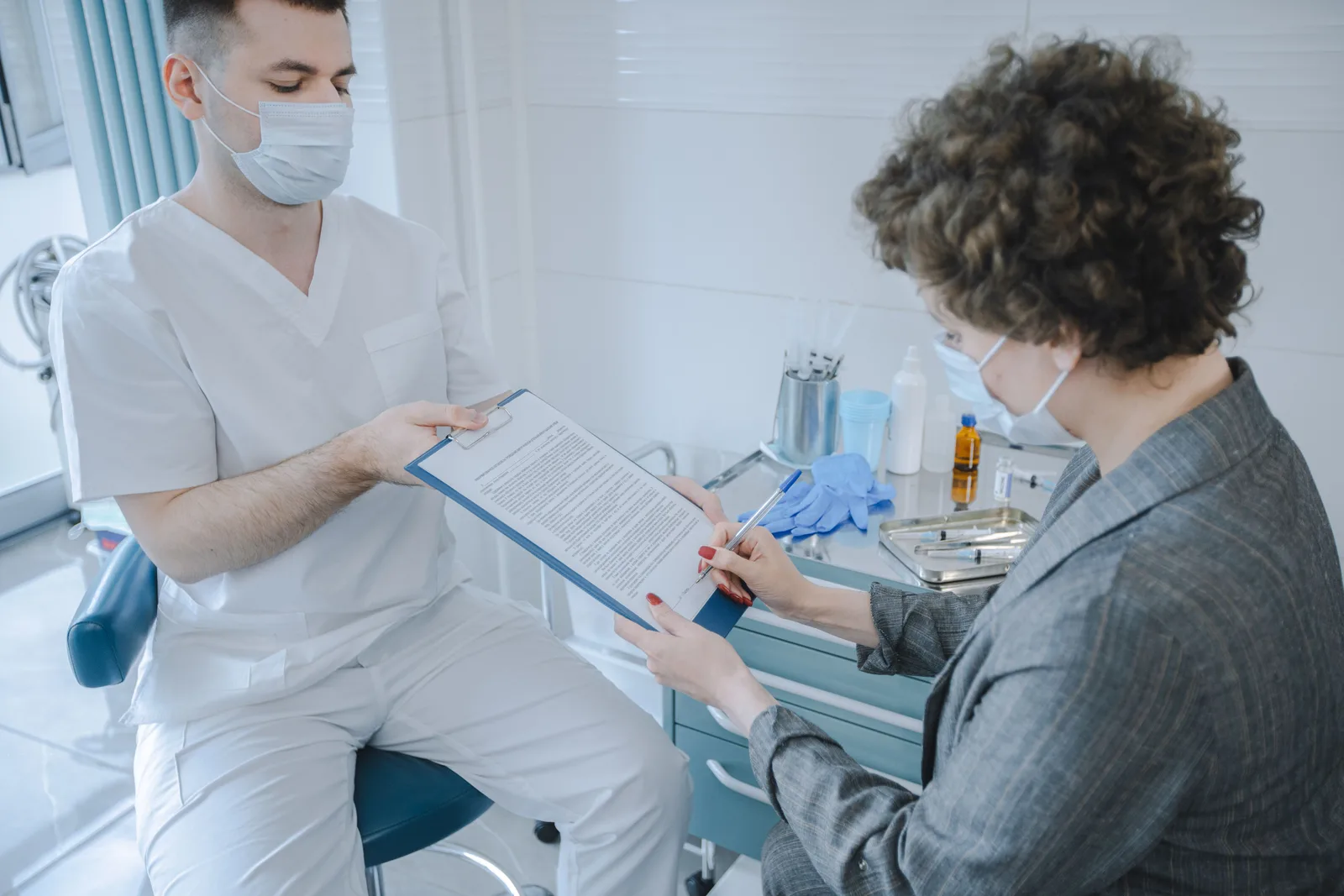 A medical professional and patient reviewing documents in a clinic setting. Healthcare Content Marketing Checklist for Launch