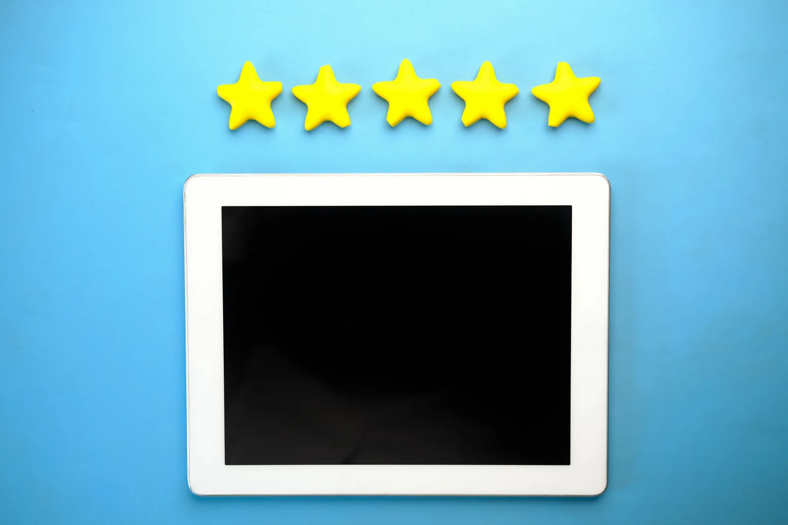 Tablet with five yellow stars on a blue background, ideal for rating concepts. Spotting Healthcare Reputation Management Mistakes Before They Cost Money