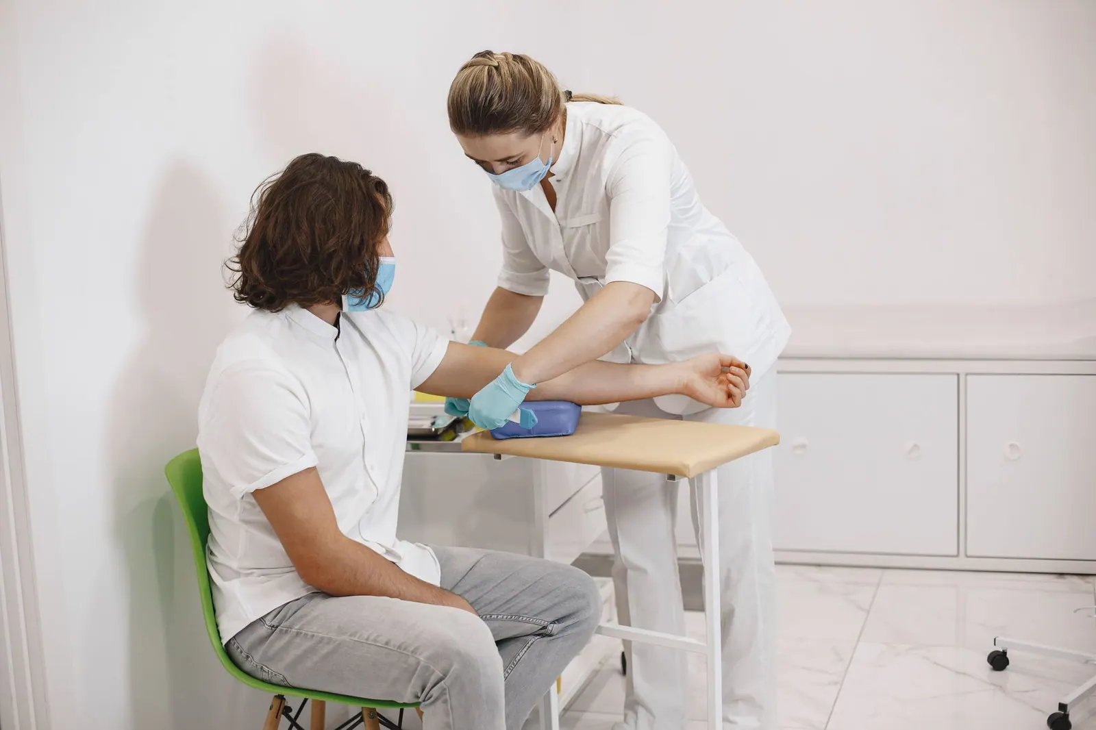A nurse aids a patient during a medical procedure in a clinical setting. Local SEO for Medical Clinics: The Google Business Profile Fixes That Move the Needle