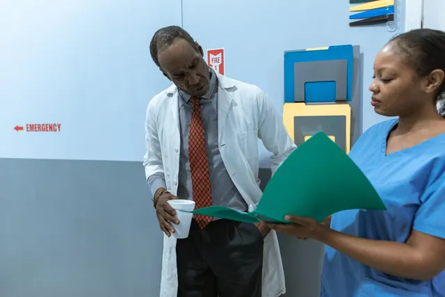 Doctors and nurse discussing medical charts in hospital setting. Medical Practice Marketing Guide for 2027