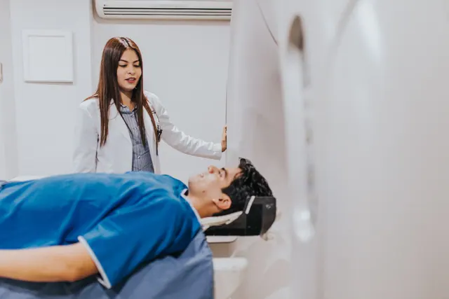 A doctor stands beside a patient in an MRI room, ensuring a smooth examination process. Patient Satisfaction Survey Questions for Clinics: The Ones That Actually Reveal Problems