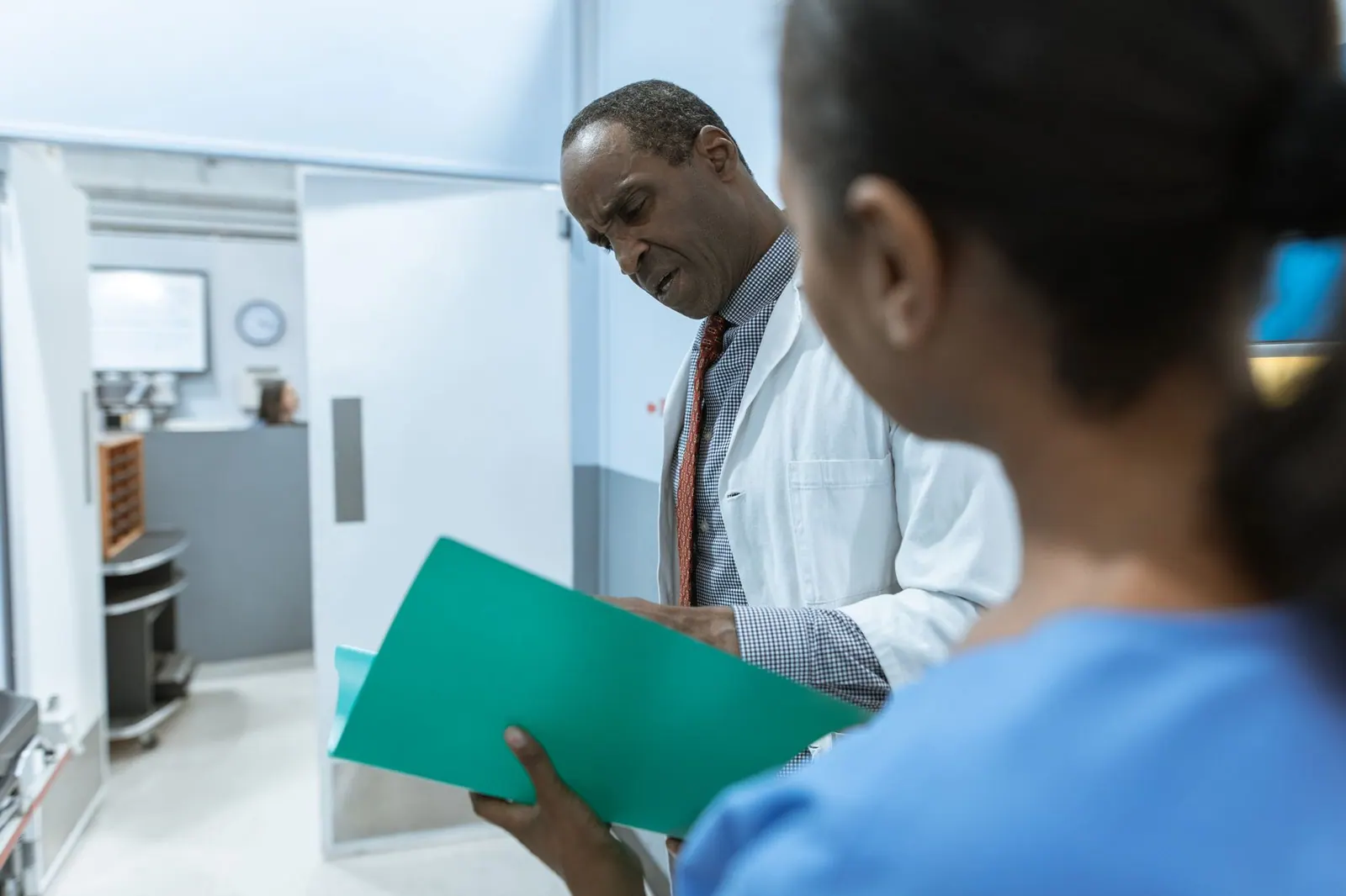 Doctors examining a folder in a hospital setting, highlighting teamwork and healthcare professionalism. PIPEDA and Patient Reviews: How Canadian Clinics Can Respond Without Breaching Privacy